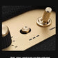 Macro shot of the Marshall Woburn III’s brass-finished control panel, featuring tactile power, volume, bass, and treble knobs for precise sound adjustment.