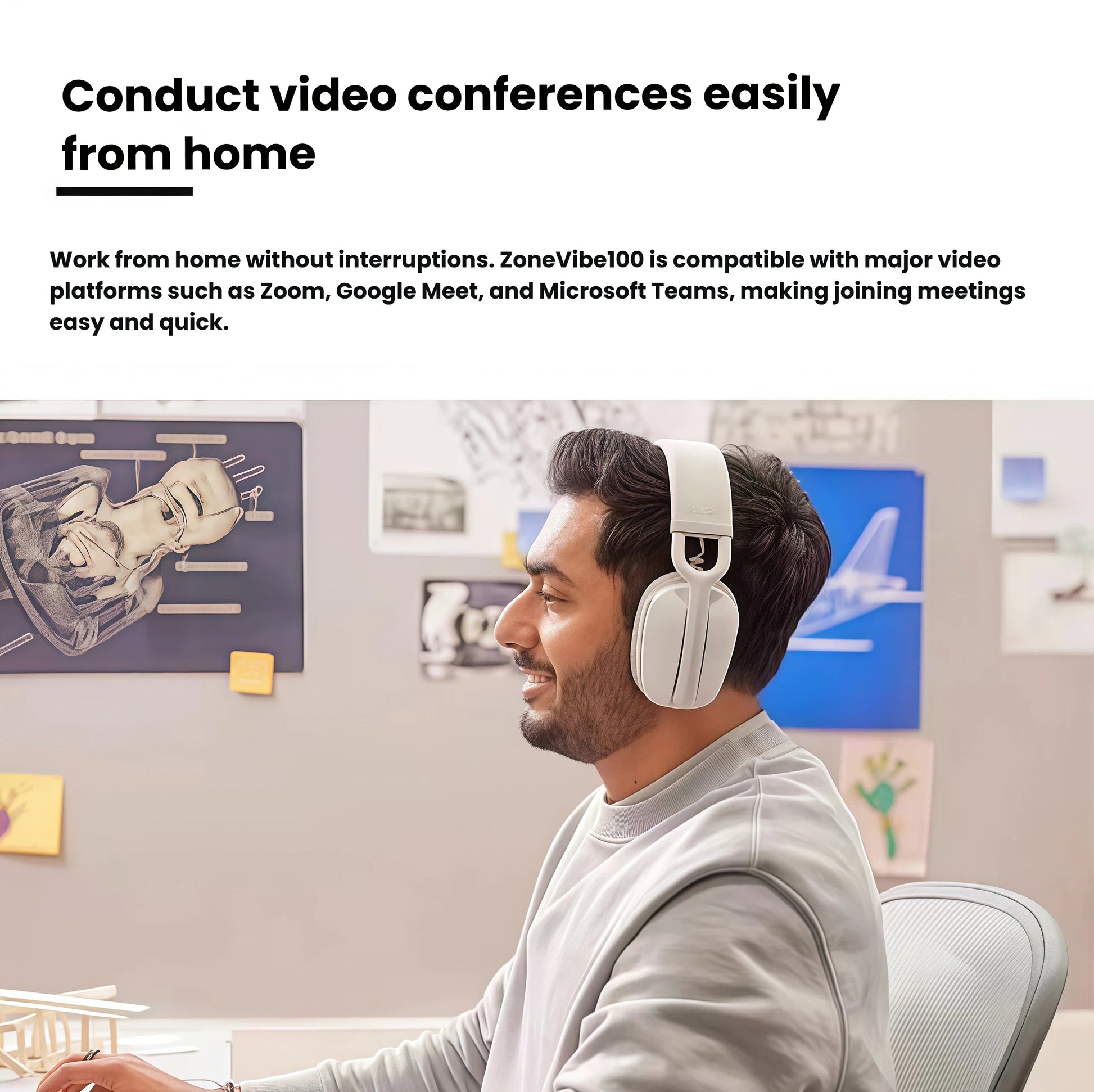 Man wearing the off-white Zone Vibe 100 while on a video call at his desk, illustrating plug-and-play compatibility with leading conferencing platforms.