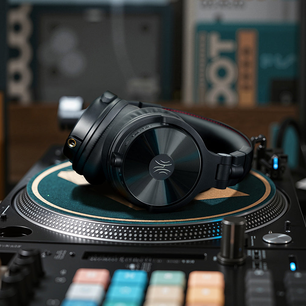 OneOdio Studio Max 2 headphones resting on a turntable; turntable not included