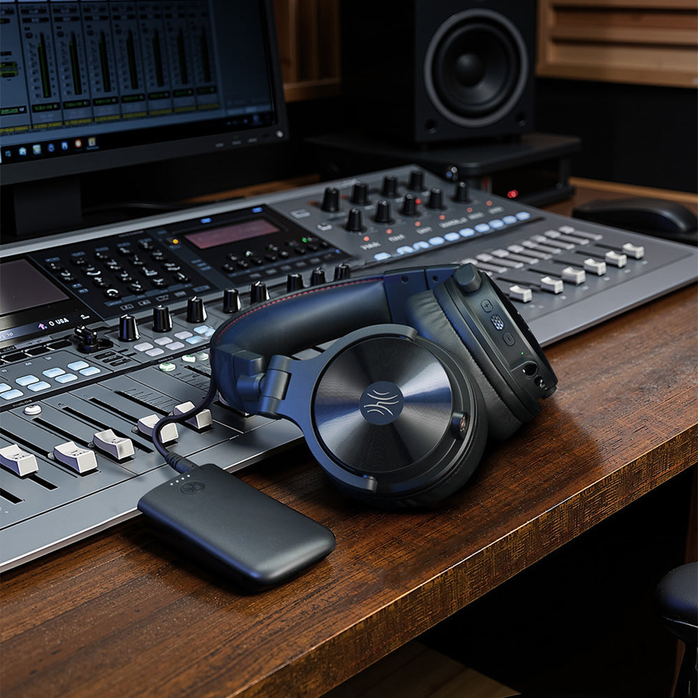 OneOdio Studio Max 2 and M2 transmitter beside a studio mixing console, console not included