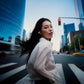 Sennheiser ACCENTUM Clip – Ice Blue earbuds worn while walking in a city